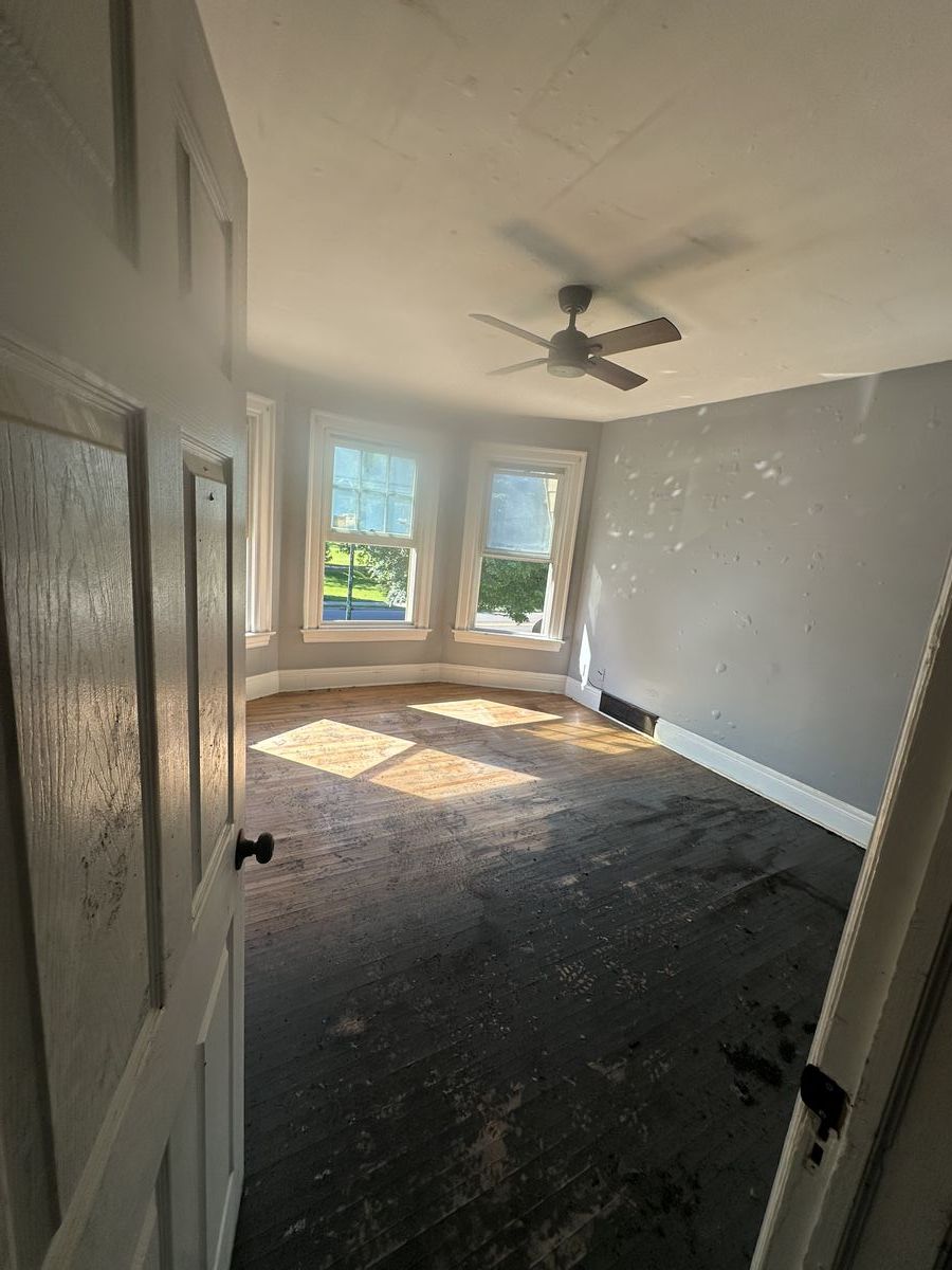 Water damage to hardwood floors with warping and discoloration